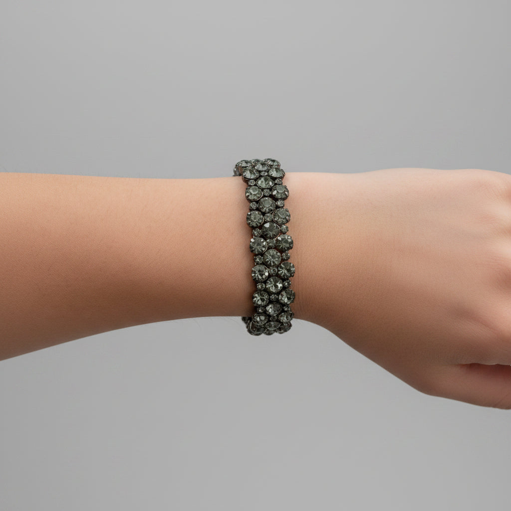 Close-up of a wrist wearing a bracelet on a neutral background
