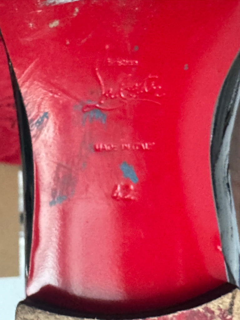Close-up of a red shoe sole with visible branding