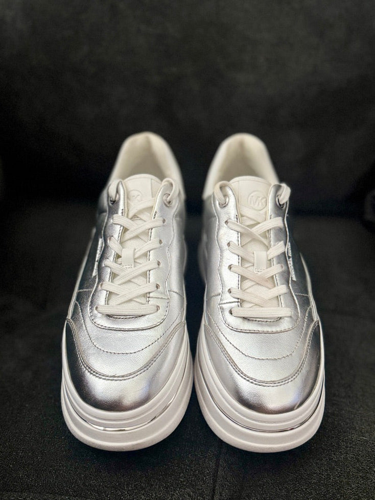 Pair of silver sneakers on a dark background