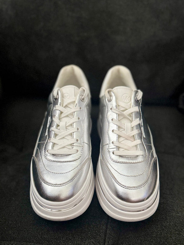 Pair of silver sneakers on a dark background