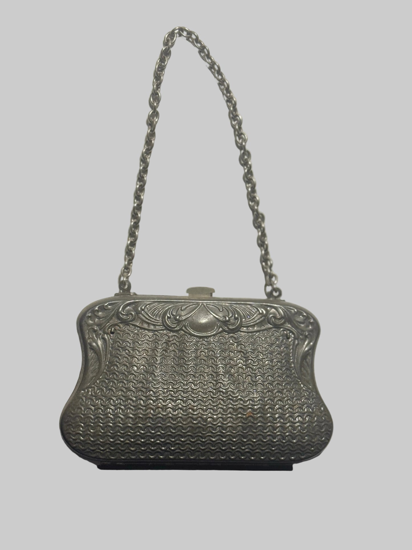 Silver vintage handbag with chain strap on a white background