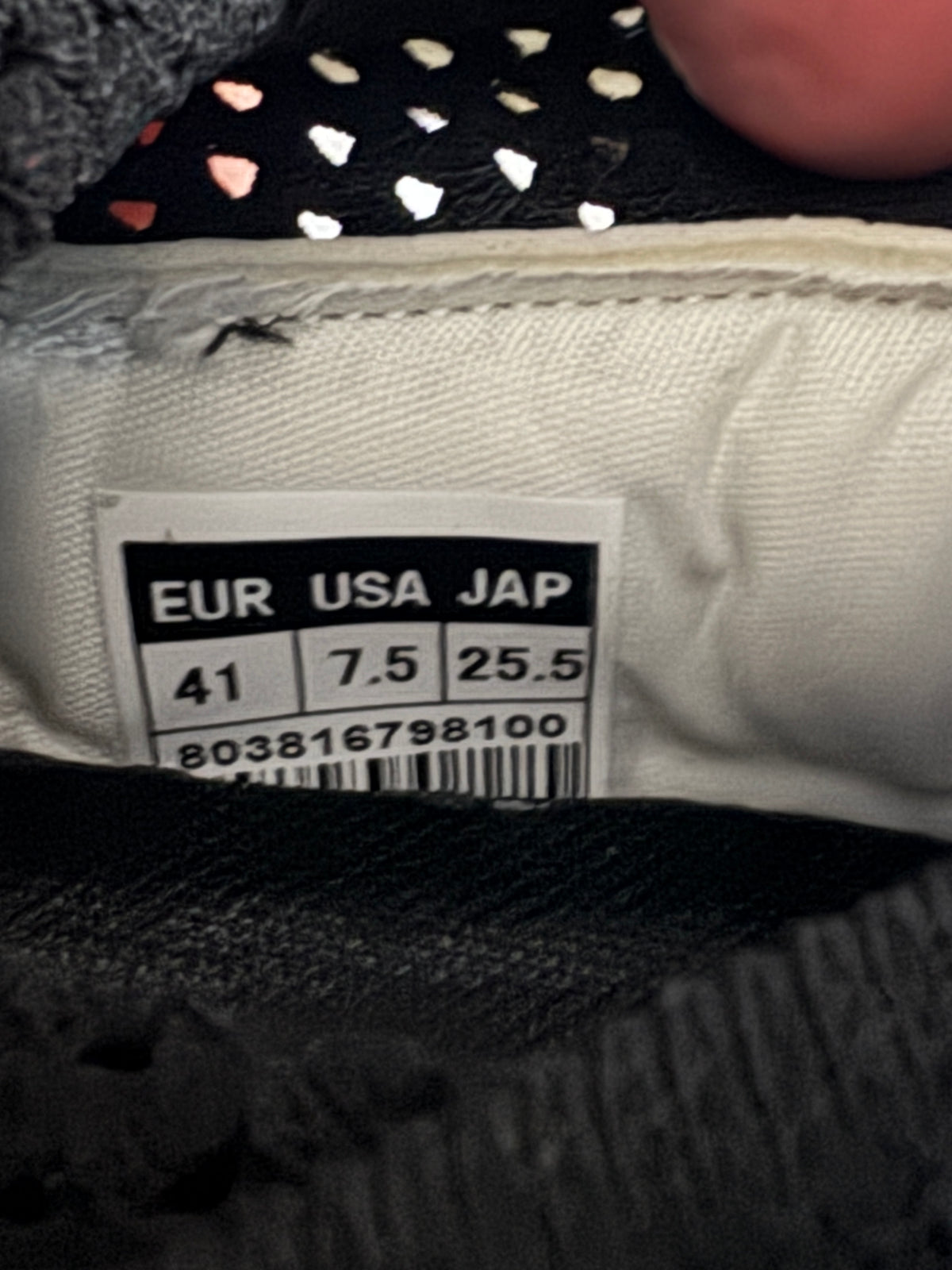 Close-up of a shoe size label showing EUR 41, USA 7.5, and JAP 25.