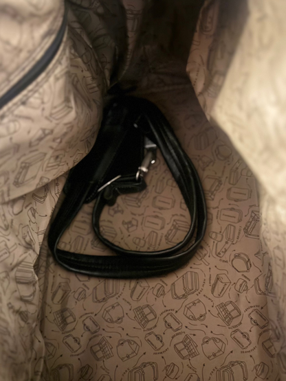 Close-up of a patterned bag interior with a black strap.