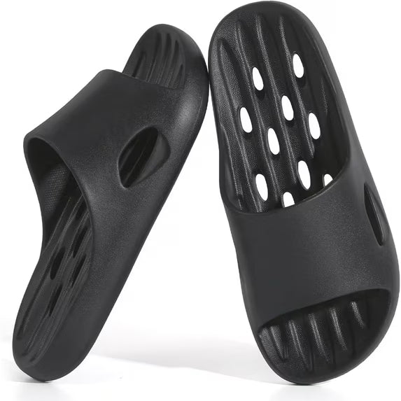 Black rubber sandals with open holes on a white background