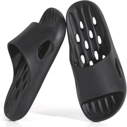 Black rubber sandals with open holes on a white background
