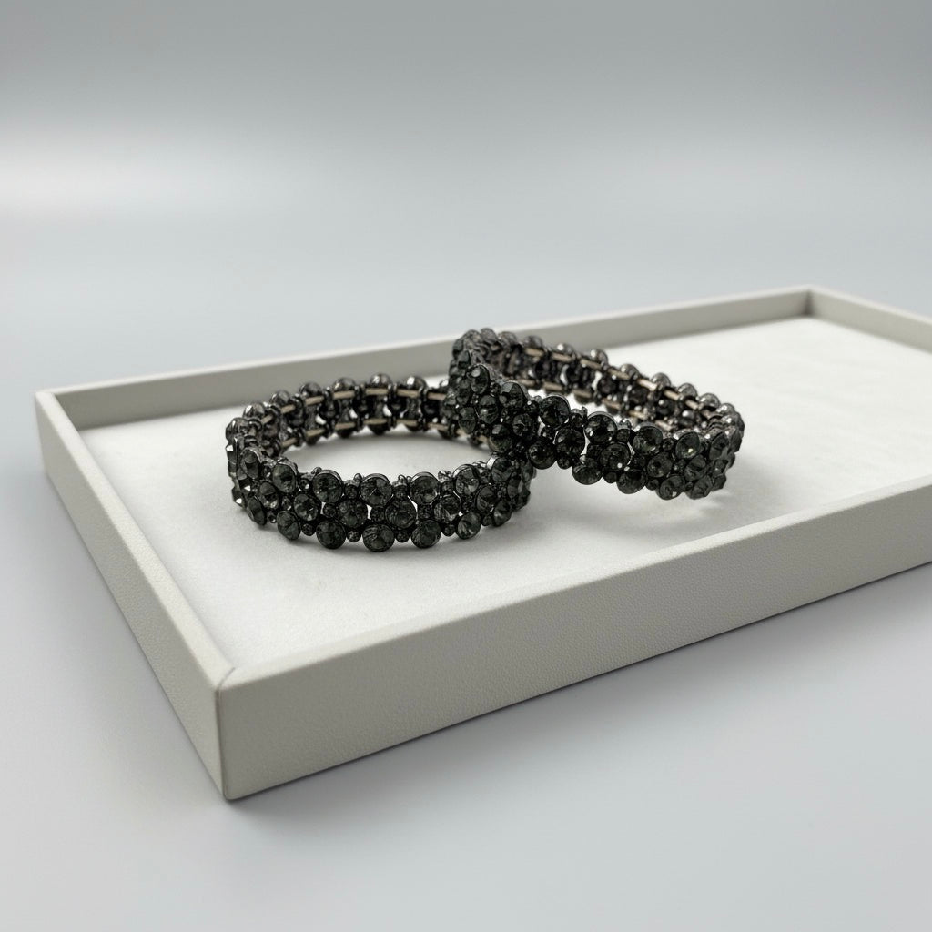 Black beaded bracelet on a white tray with a light gray background