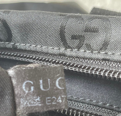 Close-up of a Gucci bag with visible branding and zipper details.