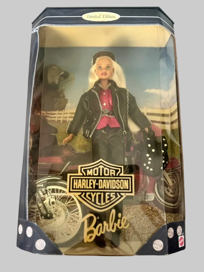 A vintage 1999 Barbie Universal Classic doll in its original window box packaging, featuring a blonde Barbie dressed in a black leather jacket and pink shirt, alongside a Harley-Davidson motorcycle.