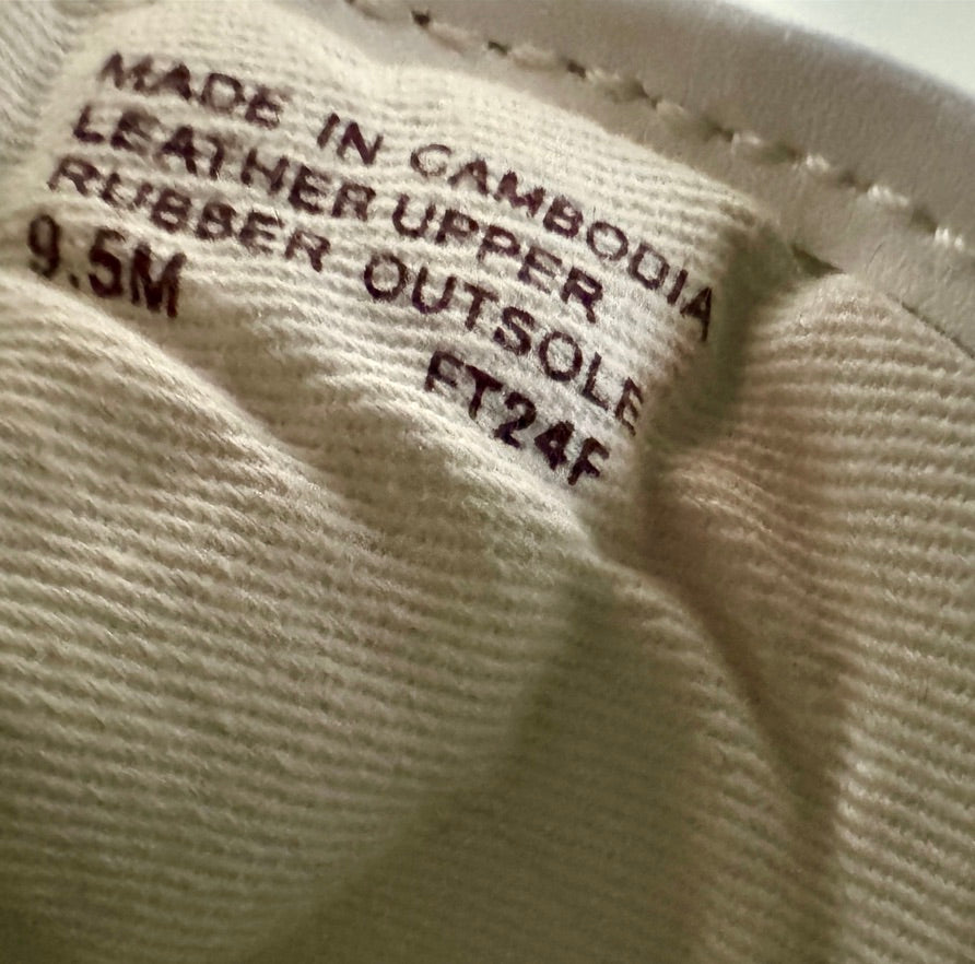 Close-up of a shoe label with text on a beige background