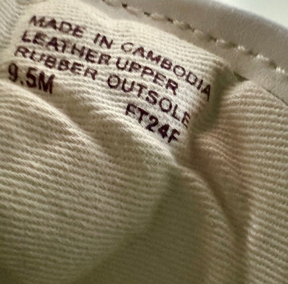 Close-up of a shoe label with text on a beige background