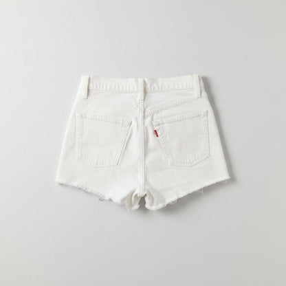 White shorts with a brand logo on a gray textured surface