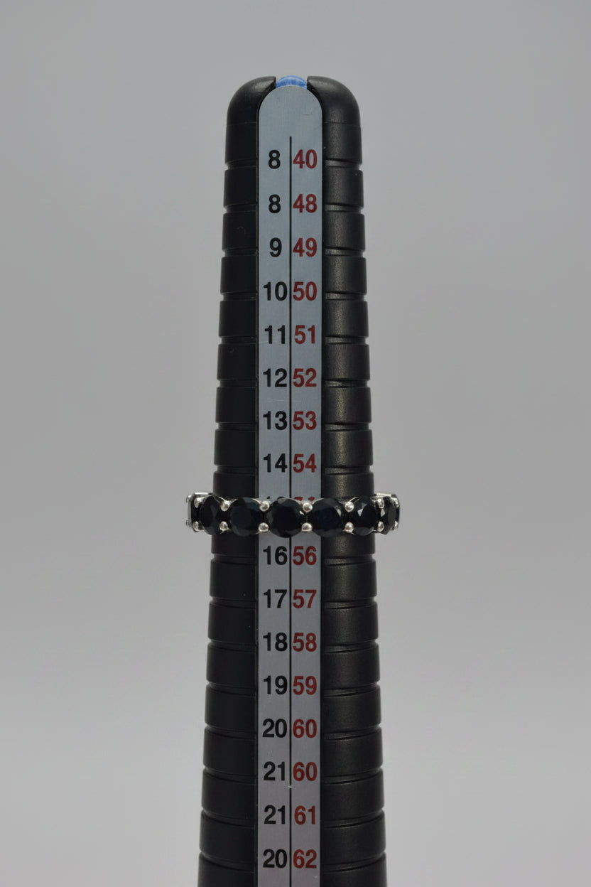 Close-up of a black cylindrical object with measurement markings on a blurred background