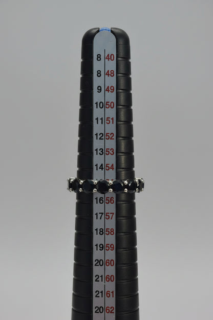 Close-up of a black cylindrical object with measurement markings on a blurred background