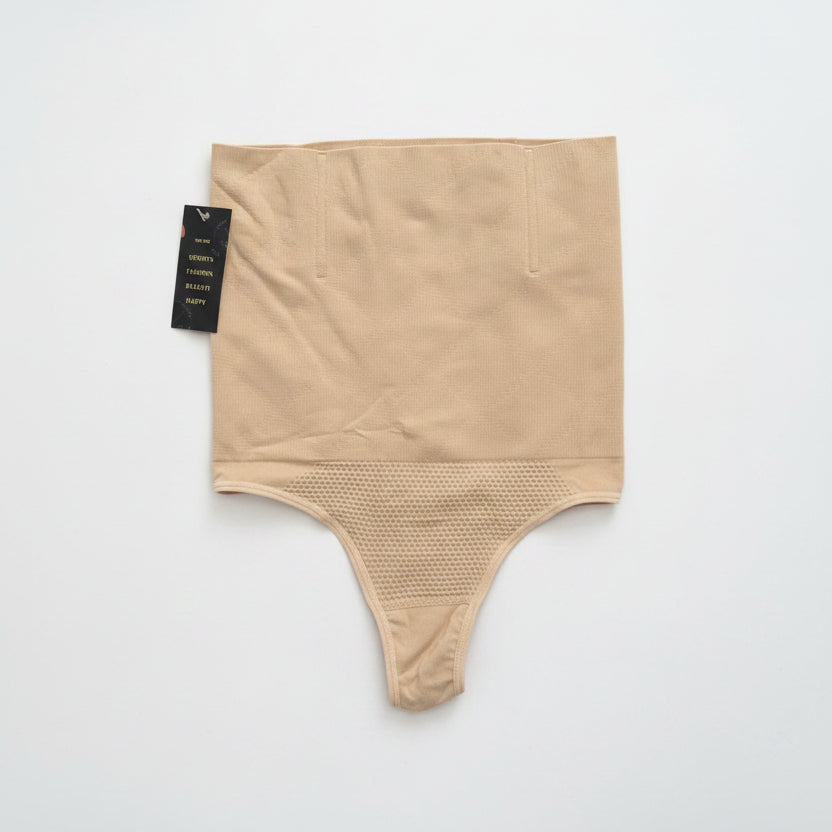 Beige shapewear with textured bottom section on a white background
