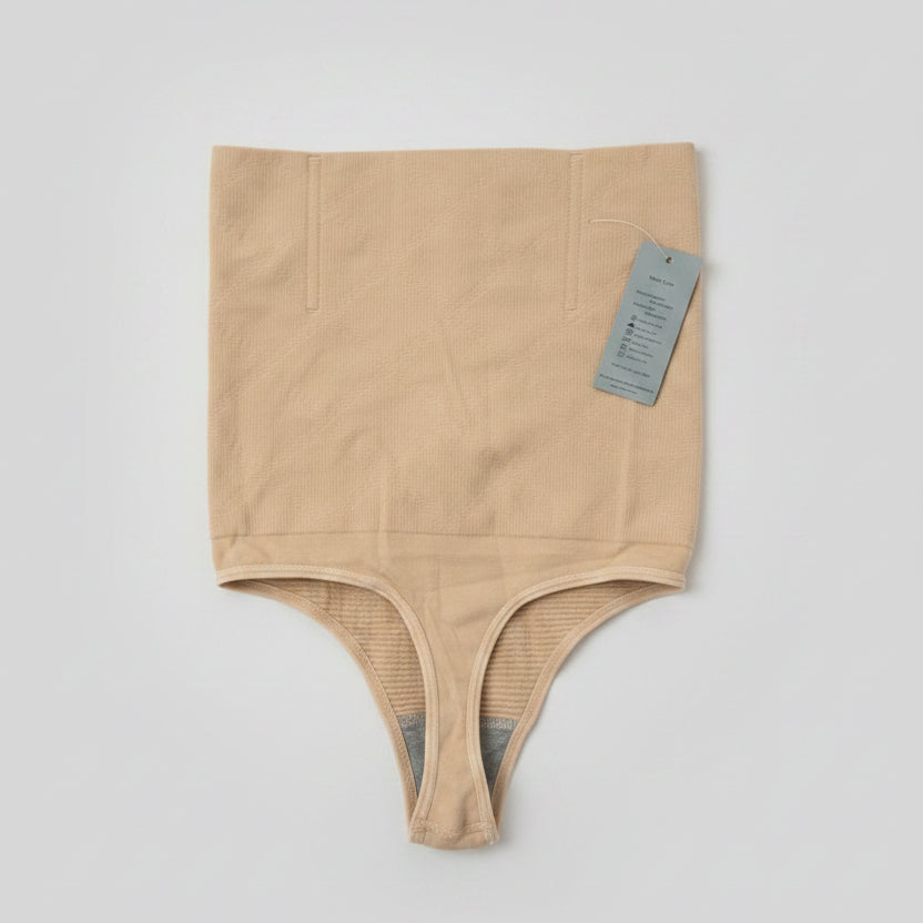 Beige shapewear with a tag on a light gray background