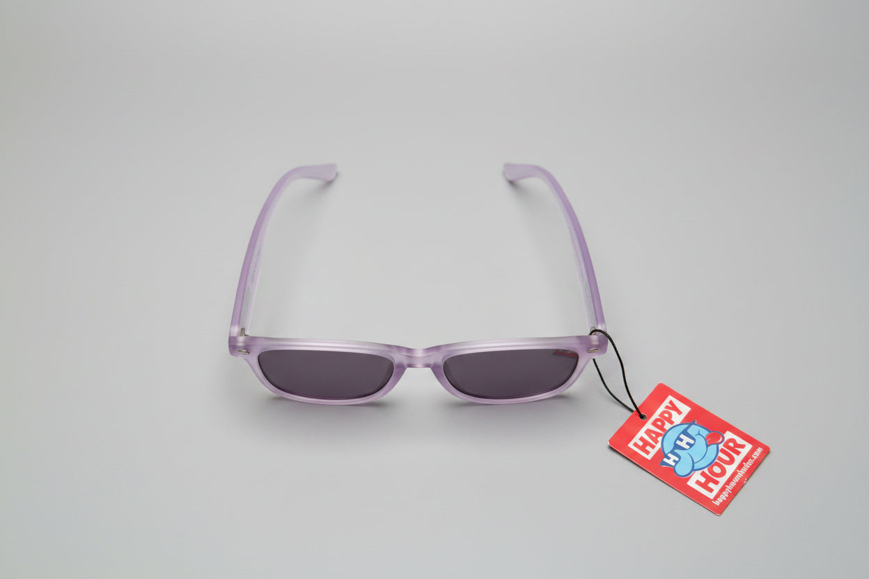 Purple eyeglasses on a gray surface with a 'Happy Hour' tag attached.