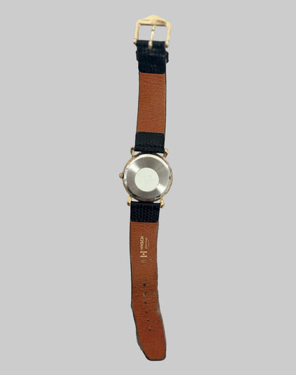 Watch with a brown strap on a gray background