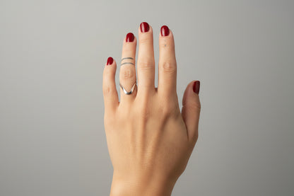 Hand with a ring on a blurred background