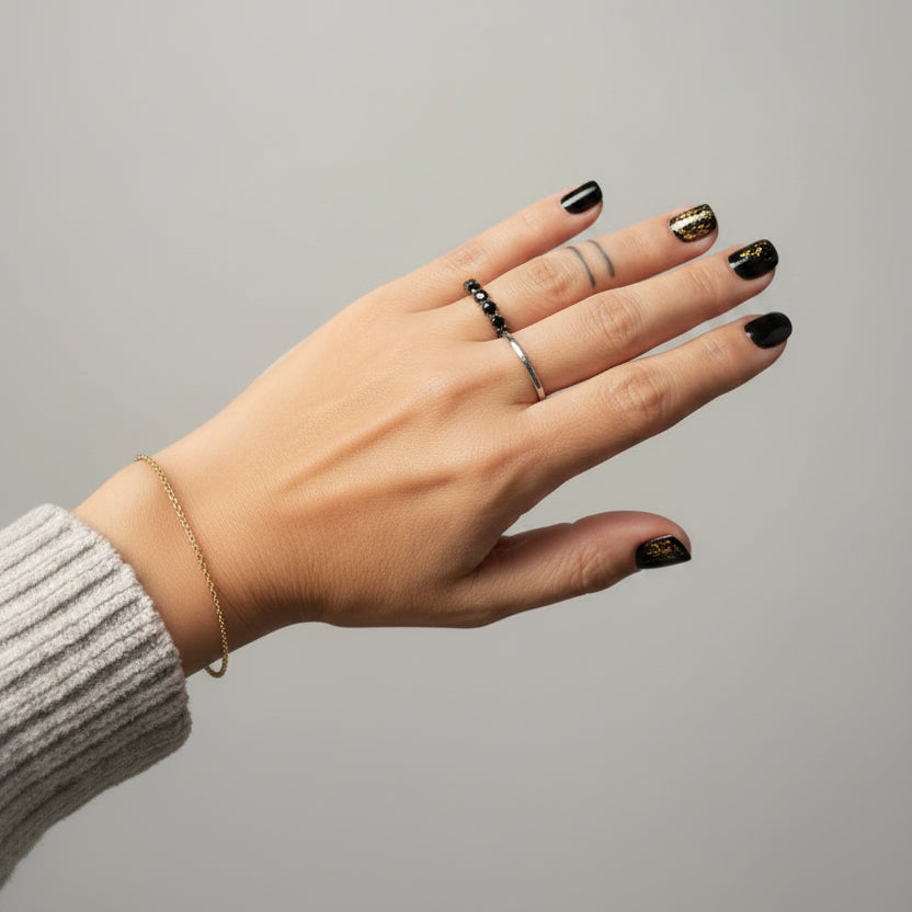 Hand with a ring in a blurred indoor setting