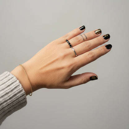 Hand with a ring in a blurred indoor setting