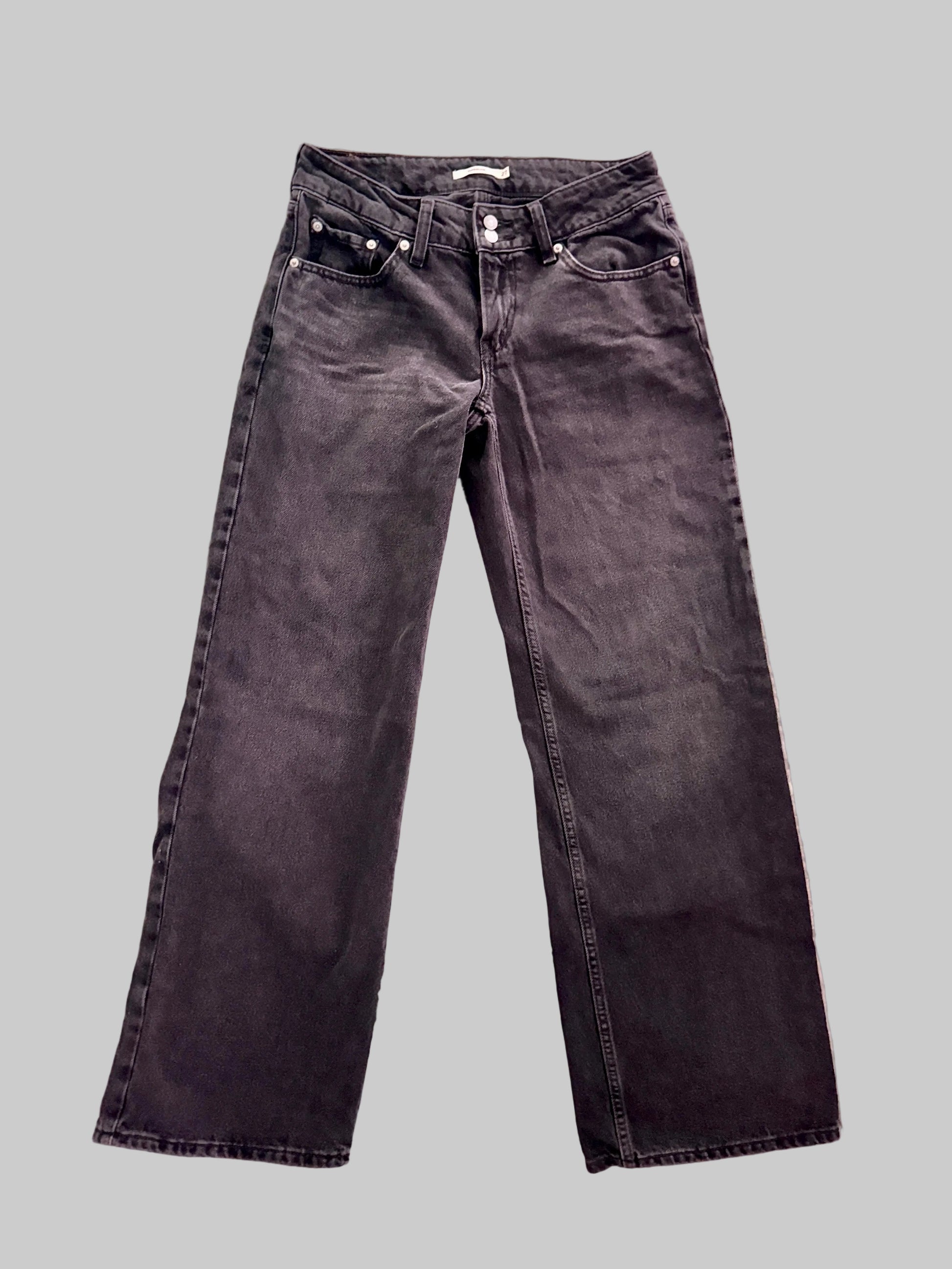 Black jeans on a textured gray surface