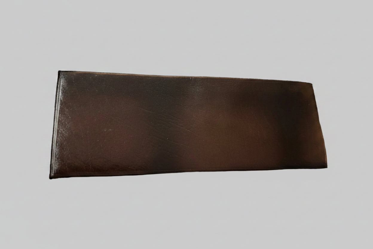 Brown leather wallet on a textured gray surface