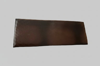 Brown leather wallet on a textured gray surface