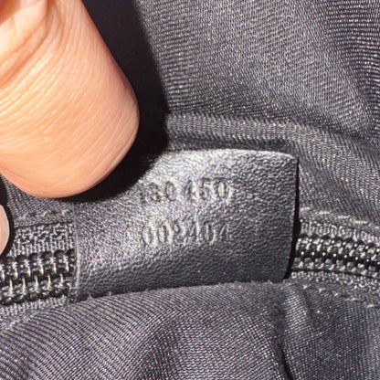 Close-up of a zipper with a brand label on a gray fabric background