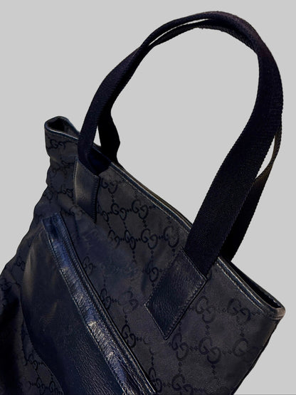 Black handbag with a pattern on a light-colored surface