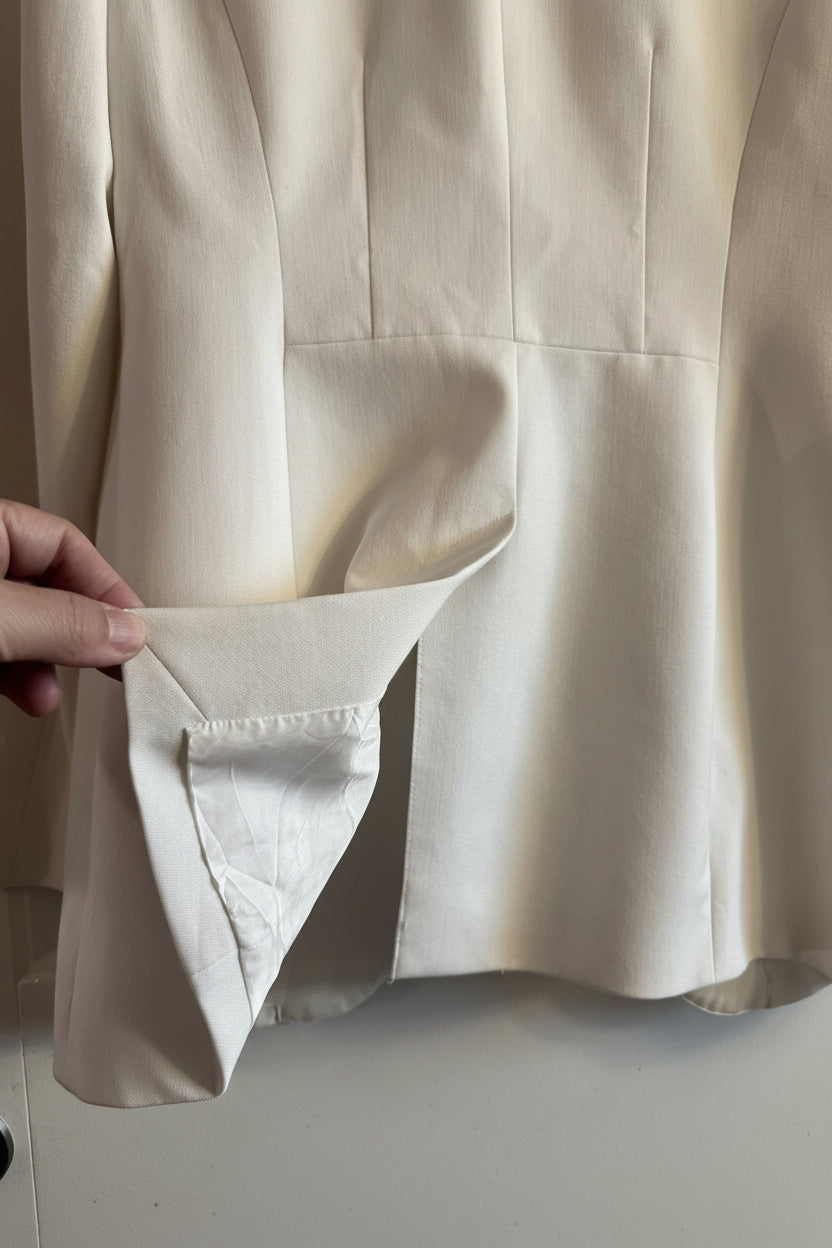 Close-up of a beige fabric with a hand adjusting it