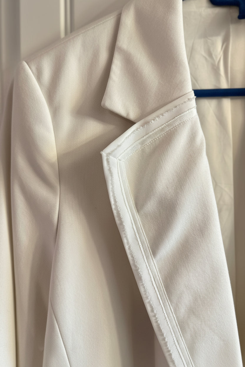 Close-up of a beige coat with a blurred background