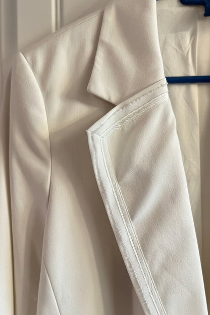 Close-up of a beige coat with a blurred background