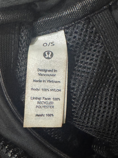 Close-up of a black mesh garment label showing the Lululemon logo and text including 'Designed in Vancouver', 'Made in Vietnam', 'Body: 100% NYLON', 'Lining: Face: 100% Recycled Polyester', and 'Mesh: 100%'.