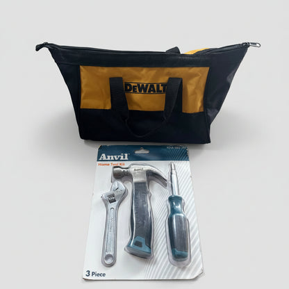 A DeWalt tool kit laid out on a beige carpet, featuring a black and yellow DeWalt tool bag, an Anvil 3-piece tool set in its retail blister packaging, and a black extension cord.