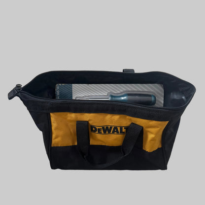 A black and yellow DEWALT tool bag filled with tools, placed on a gray carpeted floor.