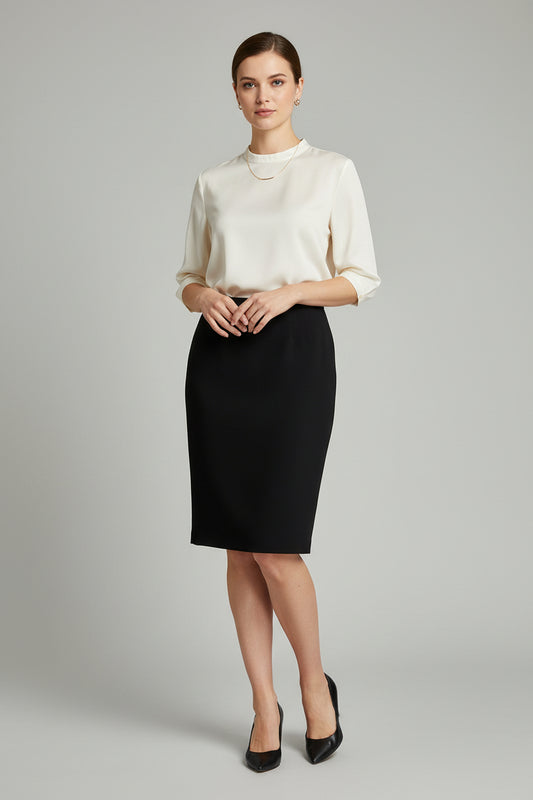 A black pencil skirt laid flat on a textured light gray fabric surface, with a small white product tag attached near the upper right side.