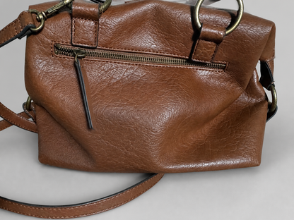 A brown faux-leather handbag with a textured finish, featuring a front zippered pocket, brass-tone hardware, and a matching shoulder strap on a neutral gray background.