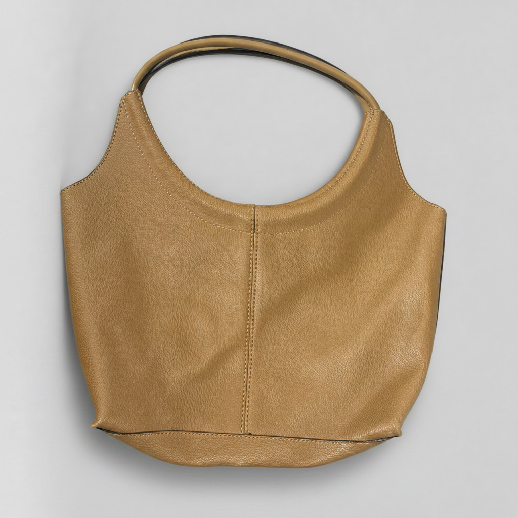 A tan leather shoulder bag with a curved, open-top silhouette and a single wide strap, photographed on a neutral light gray background.