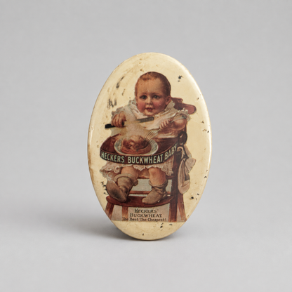 An oval vintage tin sign featuring a printed illustration of a baby in a high chair with the text 'Neckers Buckwheat Baby' and 'Neckers Buckwheat Co.,' shown on a neutral gray background.