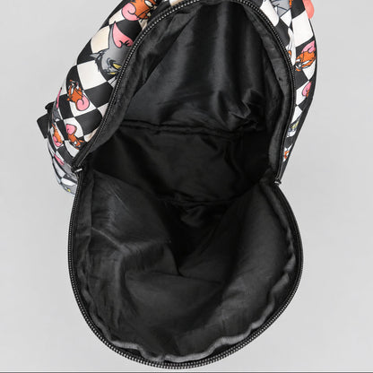 A close-up view of a backpack's open interior, showing a black nylon lining and a patterned exterior with a black and white checkerboard design and cartoon character prints.
