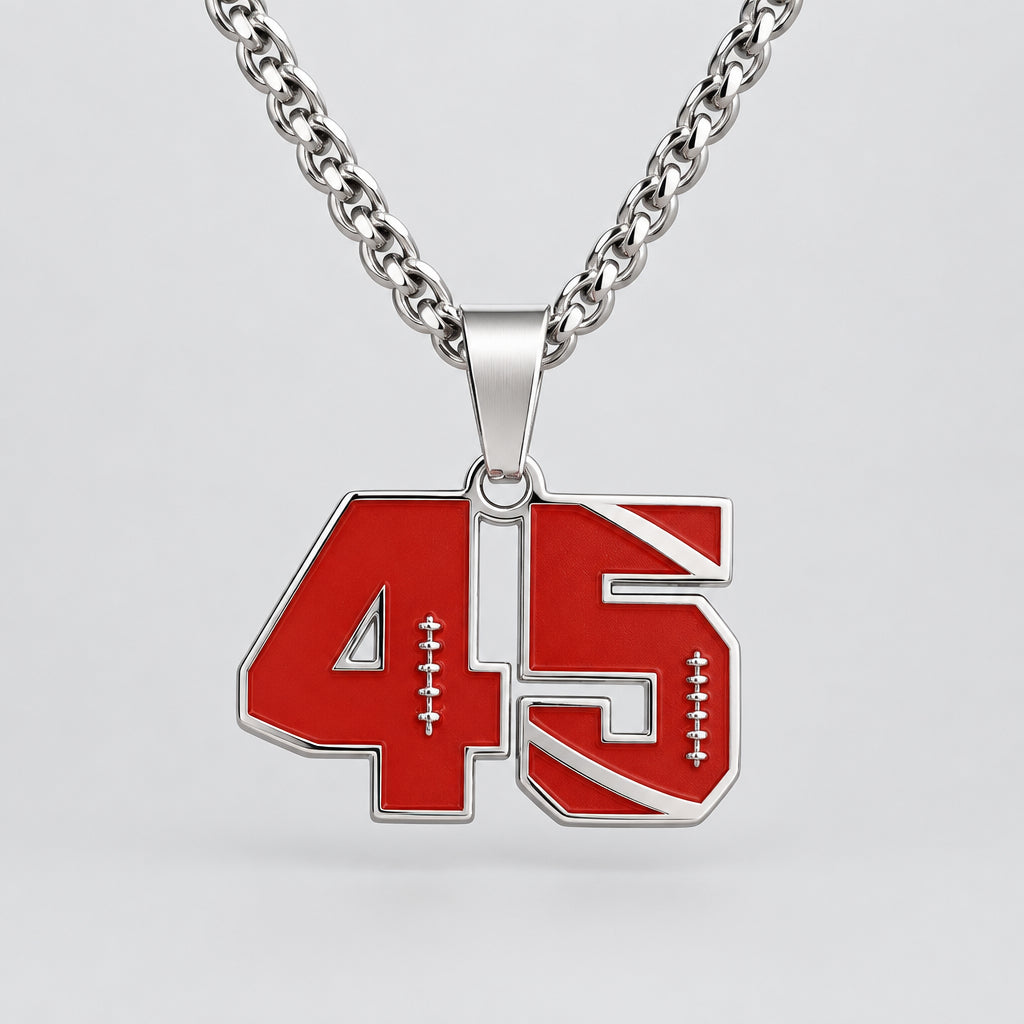 A silver chain necklace with a red and silver number 45 pendant, displayed on a black velvet jewelry bust.