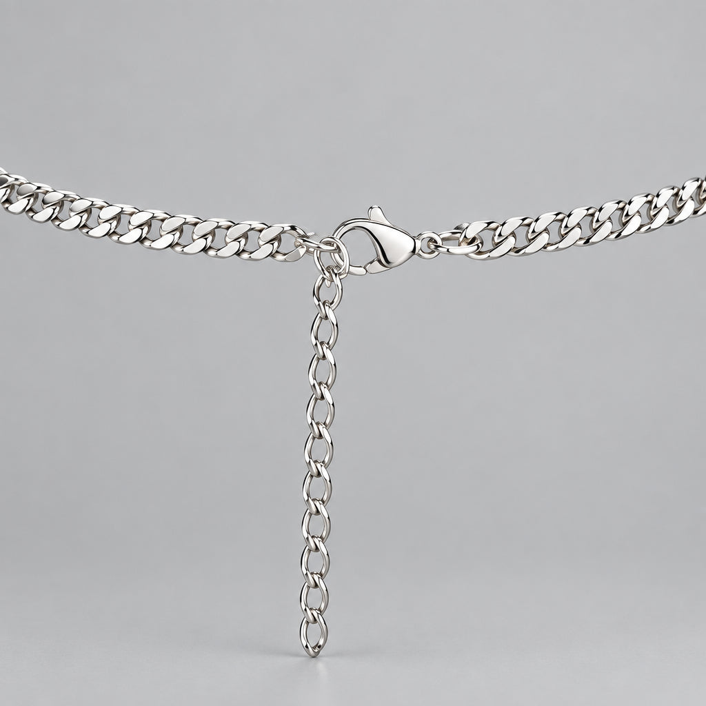 A silver metal chain necklace with a lobster clasp and an adjustable hanging extender chain, displayed on a black velvet jewelry bust.