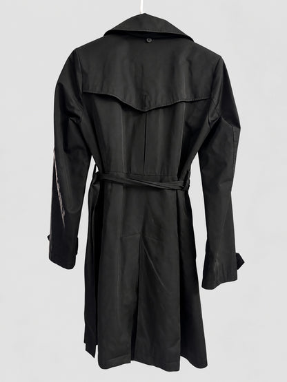 A black trench coat with a matching waist tie belt, shown from the back on a hanger against a light gray background.