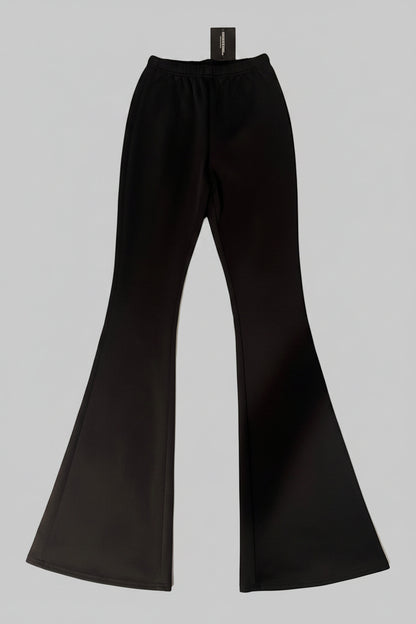 Black flared pants on a textured surface