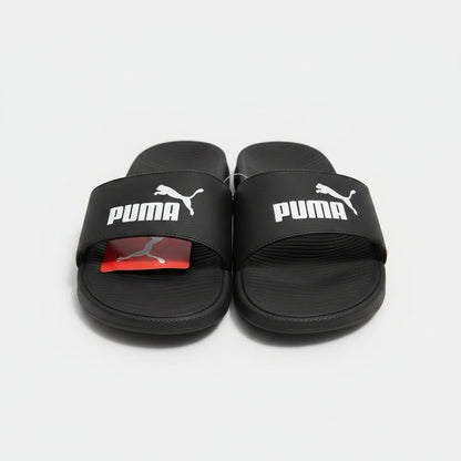 Black Puma slides on a textured surface