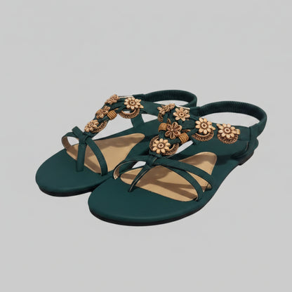 Green sandals with decorative straps on a textured surface