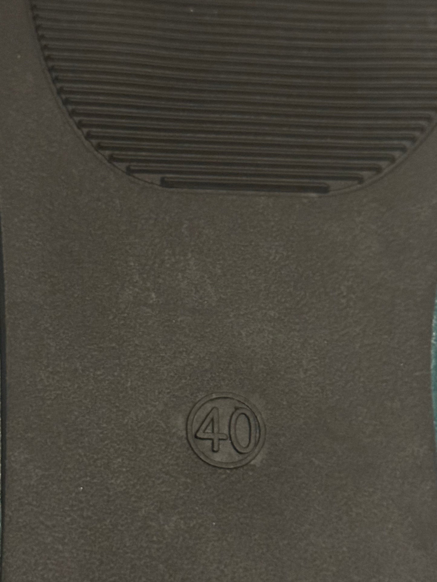 Black car mat with a '40' logo on a textured surface