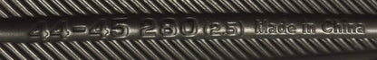 Close-up of bottom of shoe with engraved text on a carpeted floor.