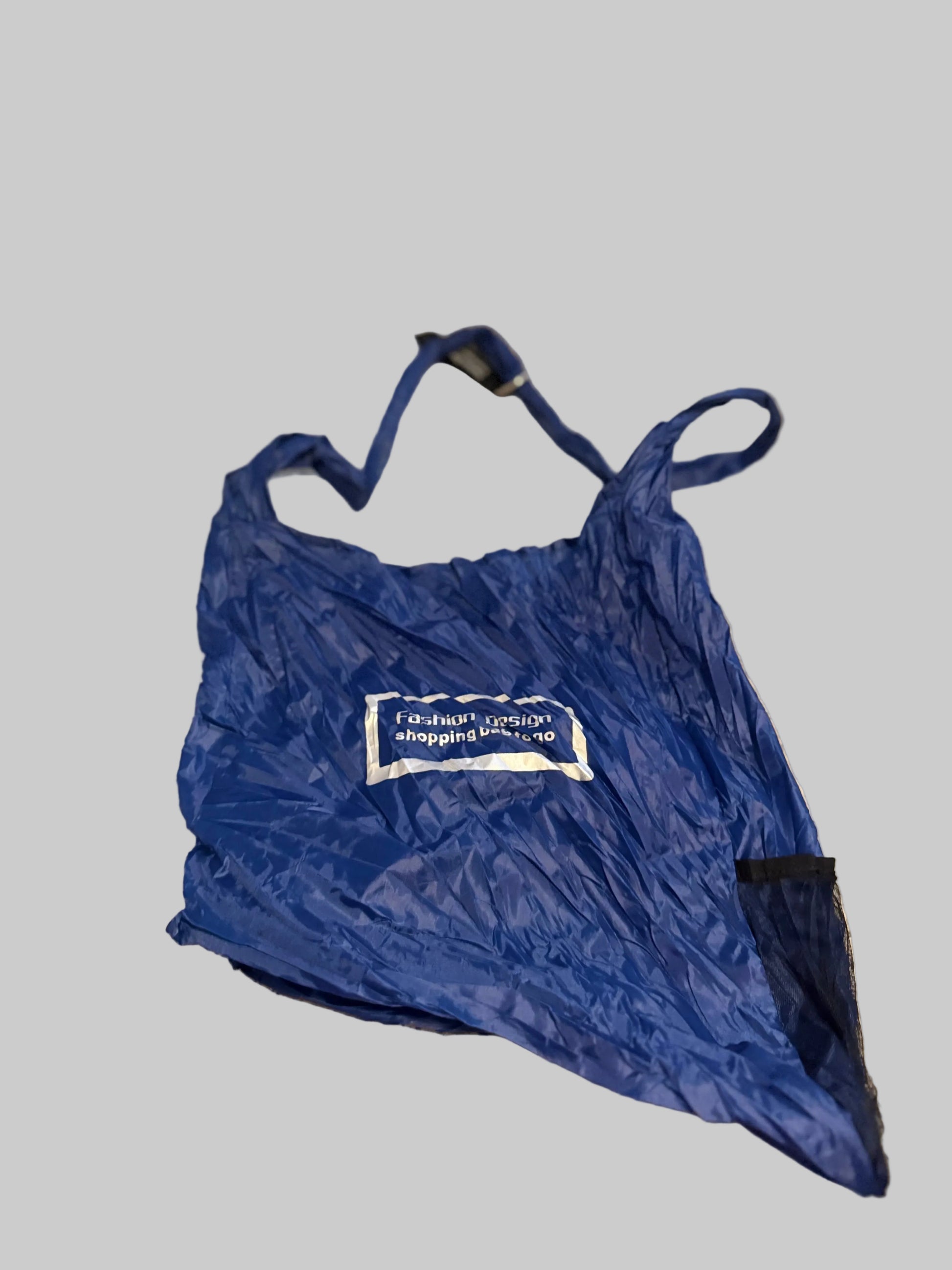Blue bag with a visible brand logo on a beige carpet