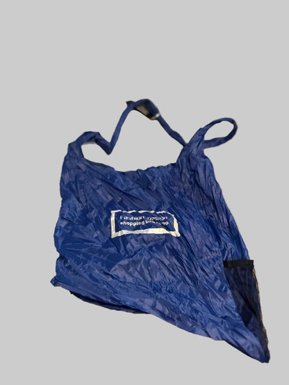 Blue bag with a visible brand logo on a beige carpet
